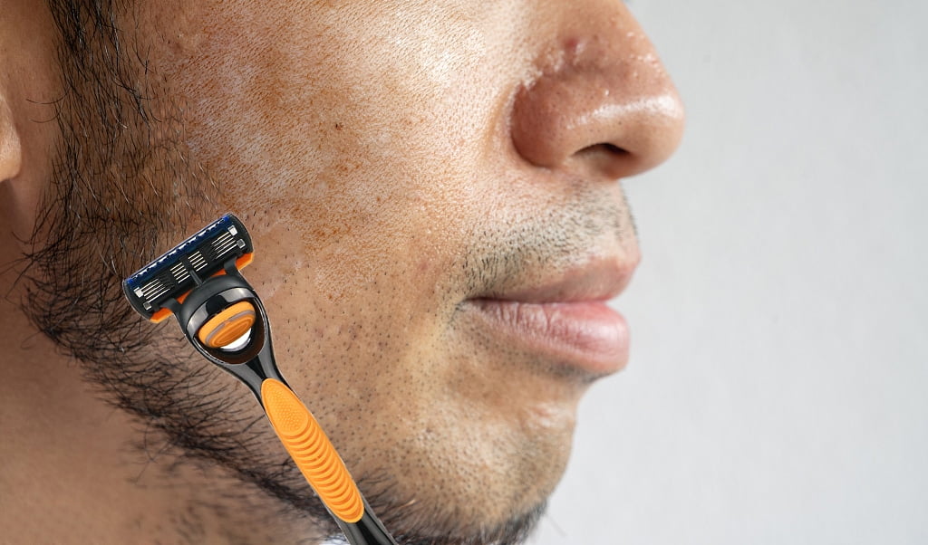 a beared man using baili "Rejoy" 5 blade razor